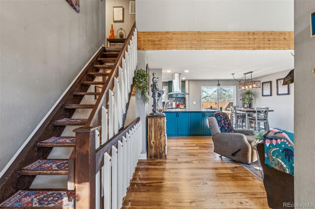 stairway with baseboards and hardwood / wood-style flooring