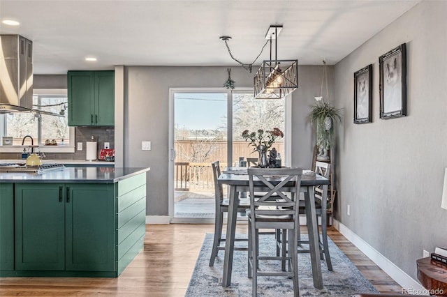 dining area with light wood finished floors, recessed lighting, and baseboards