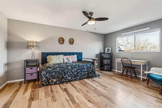 bedroom with a ceiling fan, wood-type flooring, and baseboards