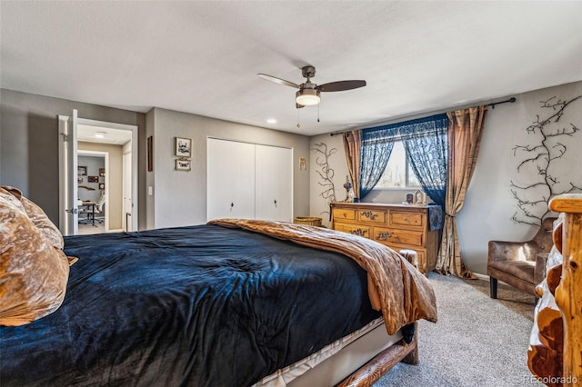 carpeted bedroom featuring ceiling fan, a textured ceiling, and a closet