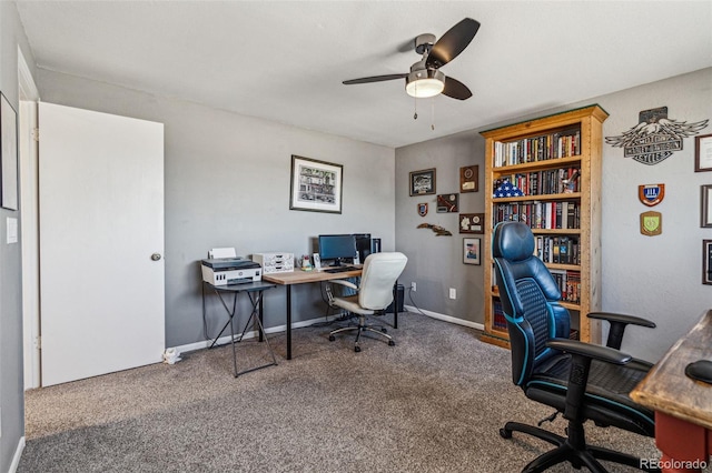 carpeted home office featuring ceiling fan and baseboards