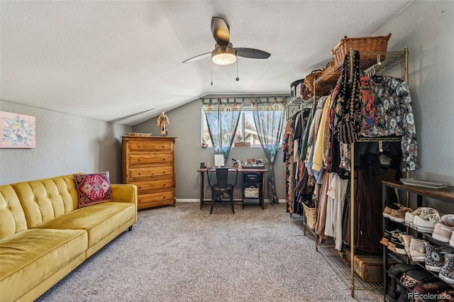 walk in closet featuring a ceiling fan, carpet flooring, and vaulted ceiling