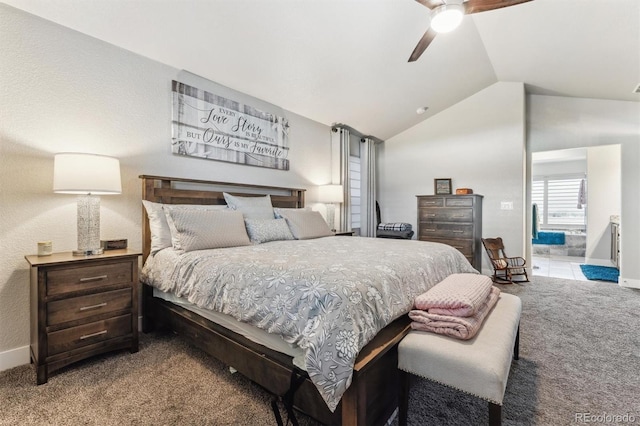 carpeted bedroom with ceiling fan, baseboards, connected bathroom, and lofted ceiling
