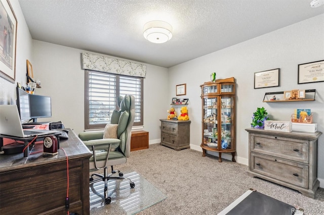 office featuring baseboards, carpet flooring, and a textured ceiling