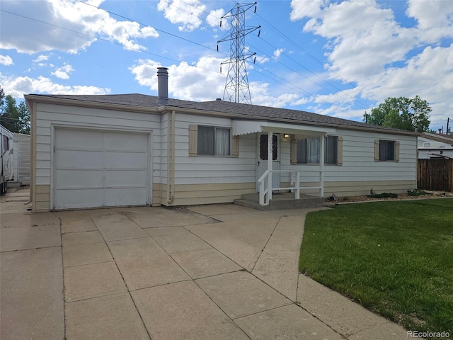 3905 Nelson St, Wheat Ridge, CO 80033 - ranch-style home with a front yard, a garage, and concrete driveway