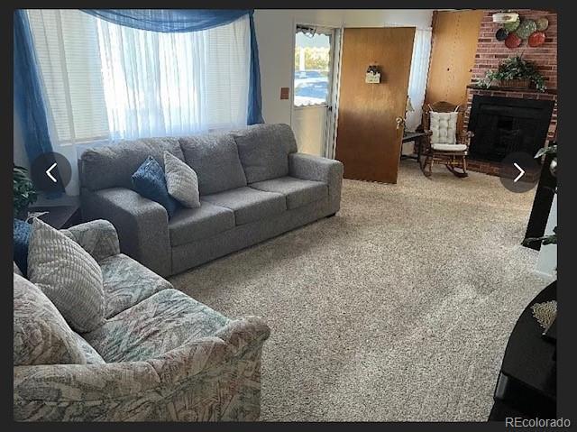 3905 Nelson St, Wheat Ridge, CO 80033 - living room with a brick fireplace and carpet floors