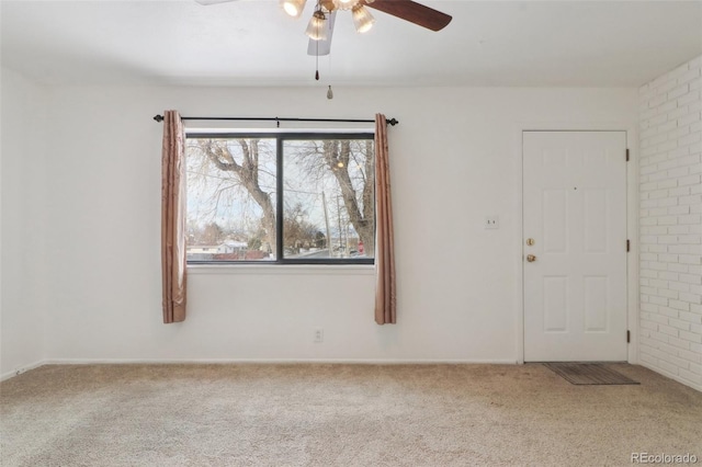 carpeted spare room with ceiling fan