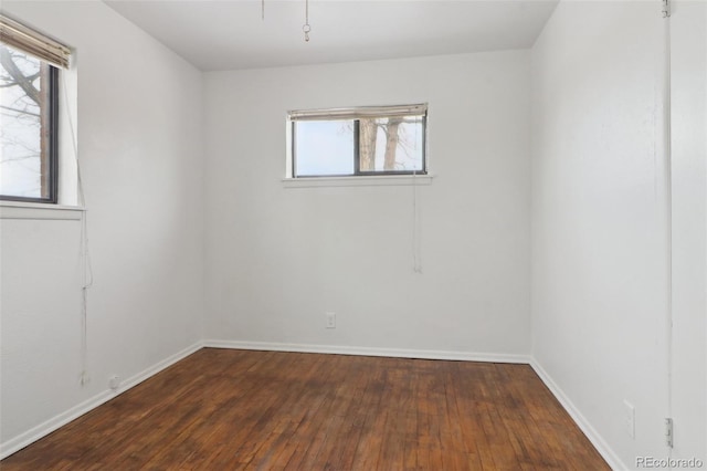 unfurnished room with dark wood-type flooring