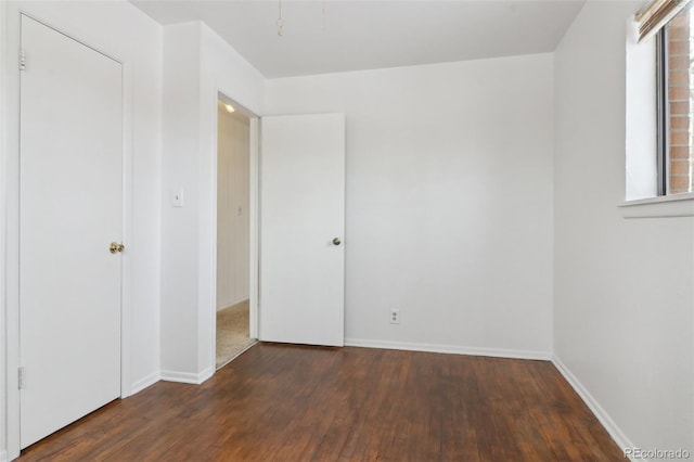 unfurnished bedroom with dark wood-type flooring