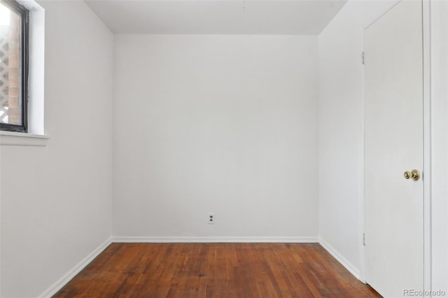 spare room featuring dark hardwood / wood-style flooring