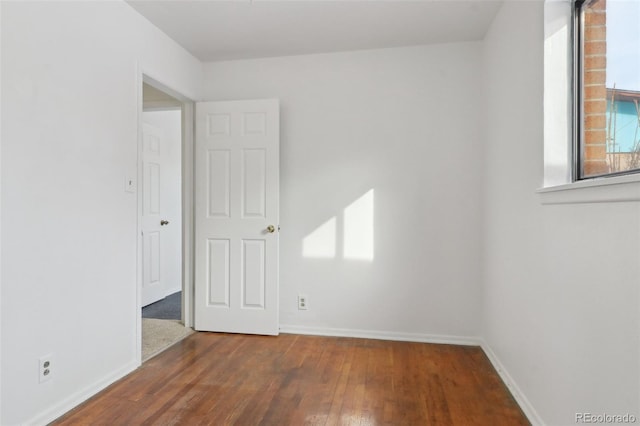 unfurnished room featuring dark hardwood / wood-style flooring