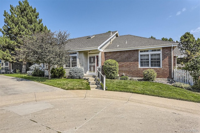 2265 S Depew St, Denver, CO 80227 - view of front facade featuring brick siding and roof with shingles