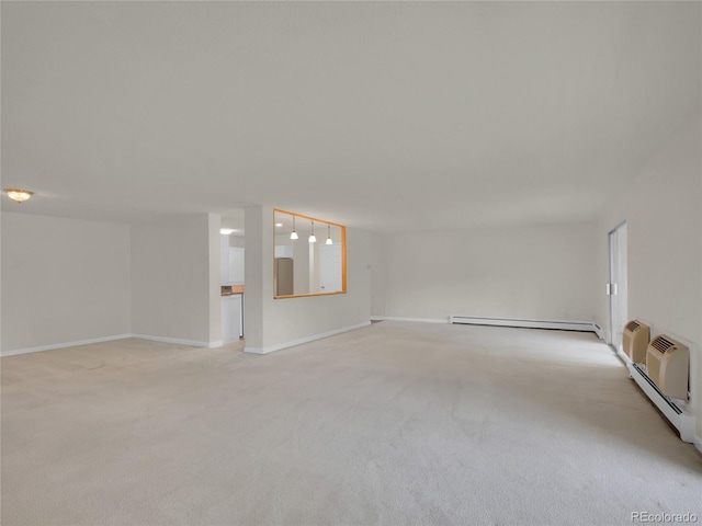 3144 S Wheeling Way Unit 206, Aurora, CO 80014 - unfurnished room featuring a baseboard radiator and light carpet