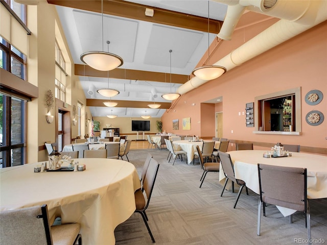 3144 S Wheeling Way Unit 206, Aurora, CO 80014 - dining room featuring a high ceiling, light carpet, and beamed ceiling