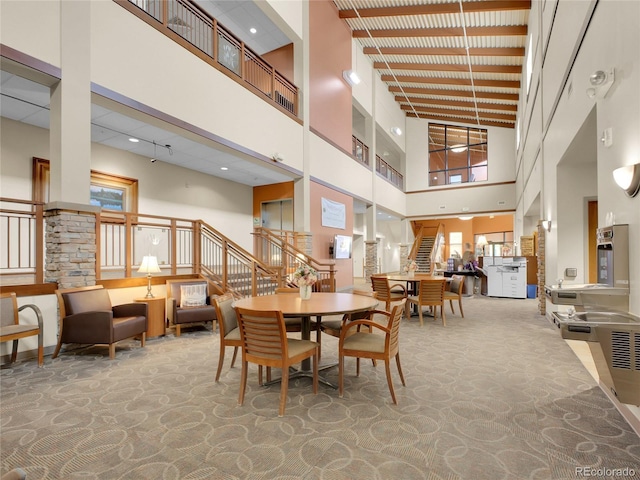 3144 S Wheeling Way Unit 206, Aurora, CO 80014 - dining space with a high ceiling, carpet floors, and stairs