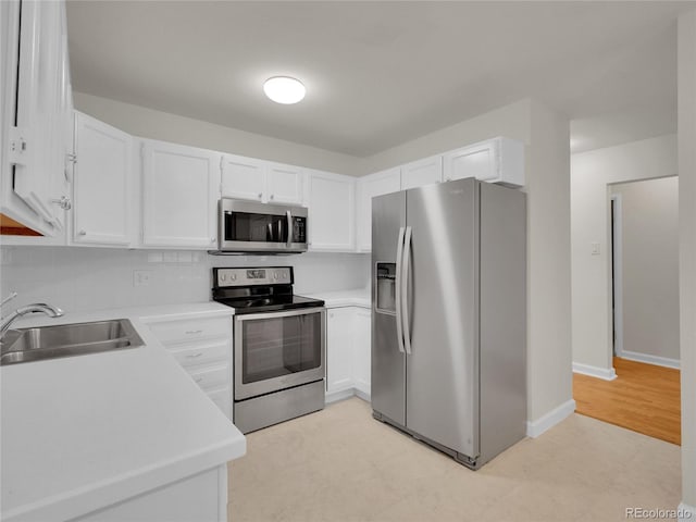 3144 S Wheeling Way Unit 206, Aurora, CO 80014 - kitchen featuring appliances with stainless steel finishes, white cabinets, and light countertops