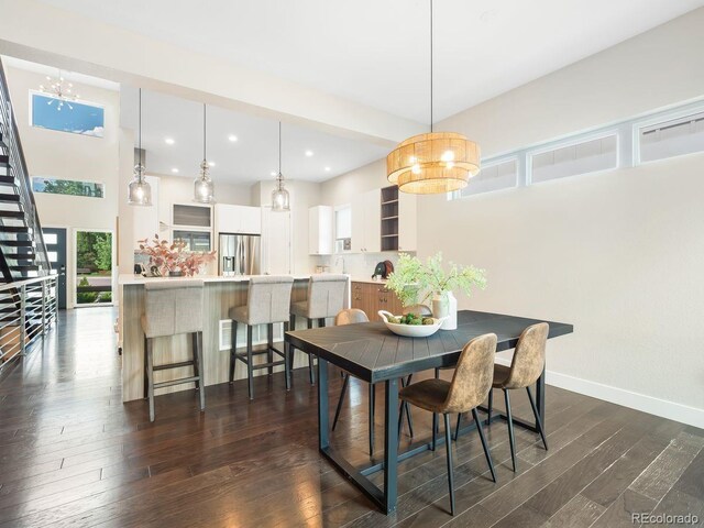 6096 W Keene Ave, Denver, CO 80235 - dining room featuring dark wood-style flooring, stairs, recessed lighting, and a chandelier