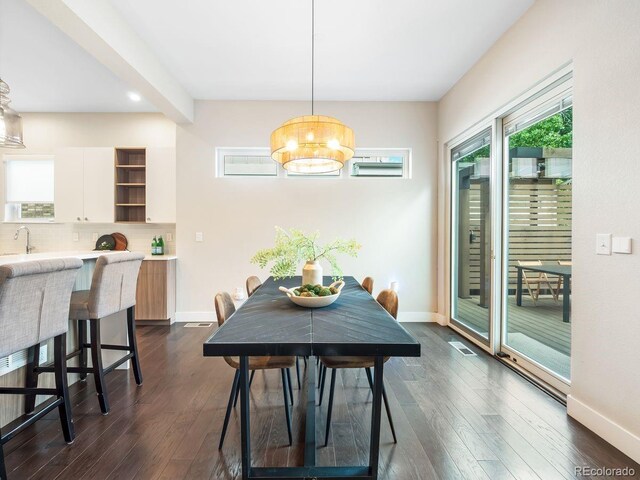 6096 W Keene Ave, Denver, CO 80235 - dining space featuring a chandelier and dark wood finished floors