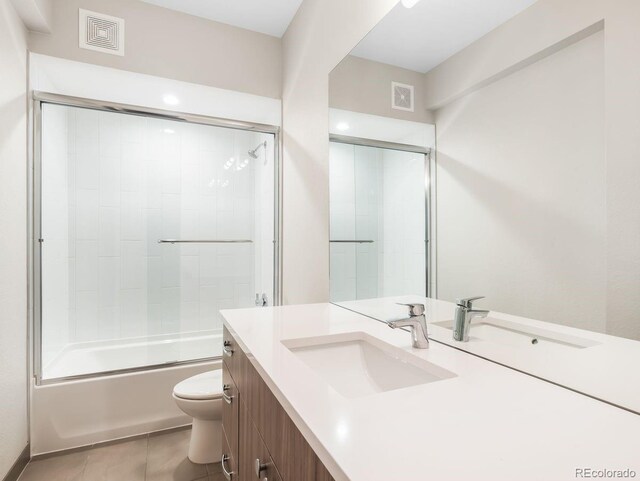 6096 W Keene Ave, Denver, CO 80235 - bathroom featuring vanity, tile patterned flooring, and combined bath / shower with glass door