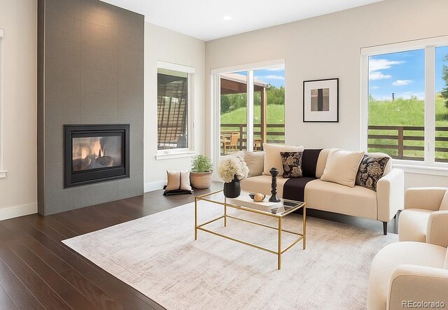 6096 W Keene Ave, Denver, CO 80235 - living room featuring healthy amount of natural light, dark wood-type flooring, a tile fireplace, and recessed lighting