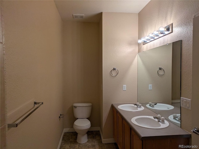 9578 Pearl Cir Unit 105, Parker, CO 80134 - bathroom with toilet, double vanity, baseboards, and tile patterned flooring
