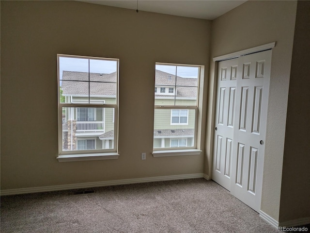 9578 Pearl Cir Unit 105, Parker, CO 80134 - unfurnished bedroom featuring carpet, a closet, and baseboards