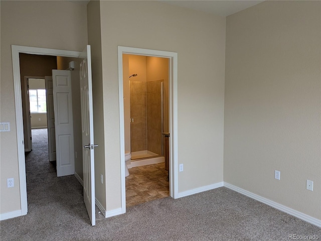 9578 Pearl Cir Unit 105, Parker, CO 80134 - unfurnished bedroom with carpet, baseboards, and ensuite bathroom