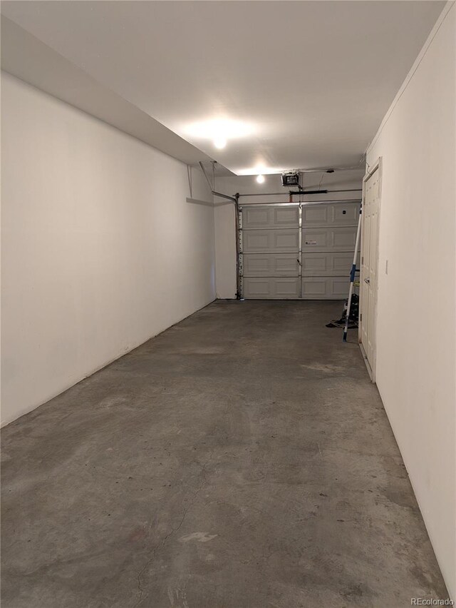 9578 Pearl Cir Unit 105, Parker, CO 80134 - garage featuring a garage door opener