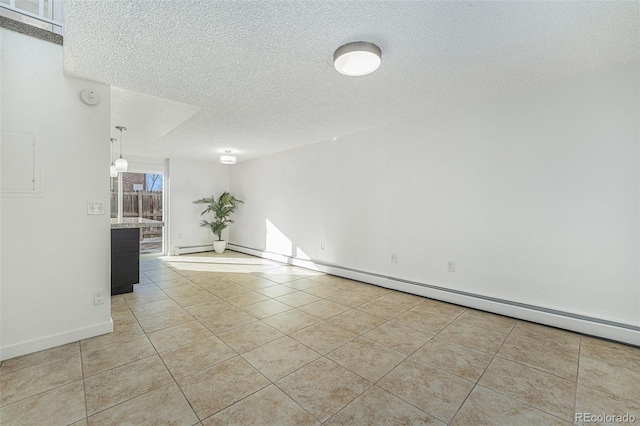 tiled spare room featuring a textured ceiling