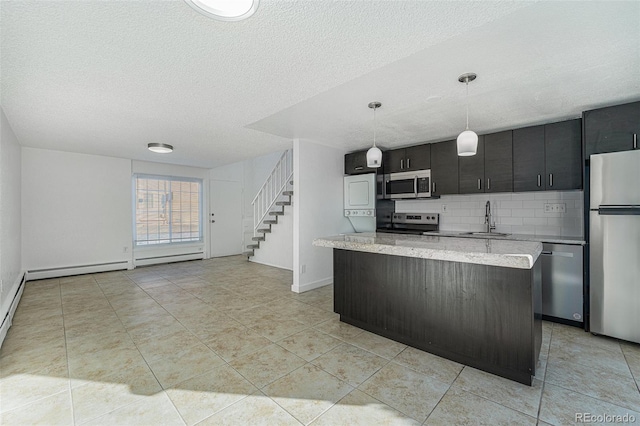 kitchen featuring a kitchen island, appliances with stainless steel finishes, decorative light fixtures, sink, and backsplash