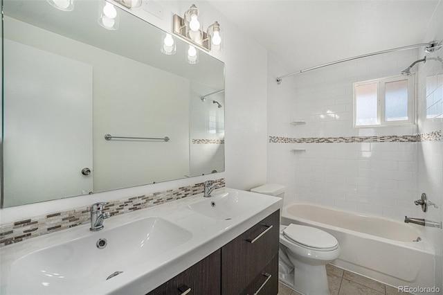 full bathroom featuring tile patterned floors, toilet, tiled shower / bath, vanity, and decorative backsplash