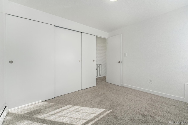 interior space featuring a closet and carpet