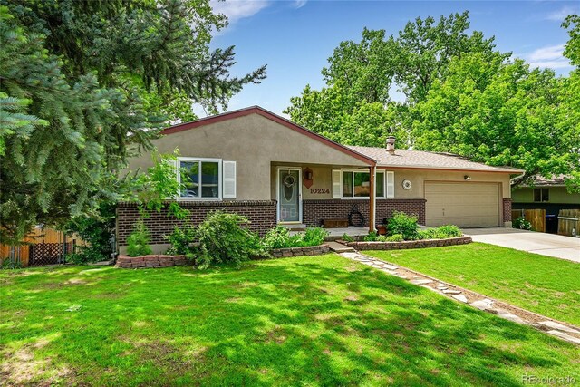 10224 W 68th Way, Arvada, CO 80004 - view of front facade with brick siding, an attached garage, concrete driveway, and stucco siding
