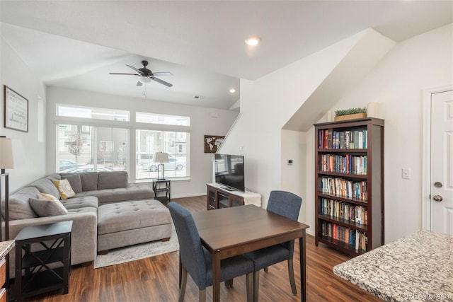 dining space with ceiling fan and dark wood-style floors