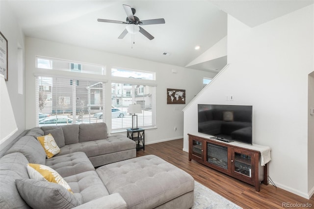 living room featuring ceiling fan, wood finished floors, healthy amount of natural light, baseboards, and lofted ceiling