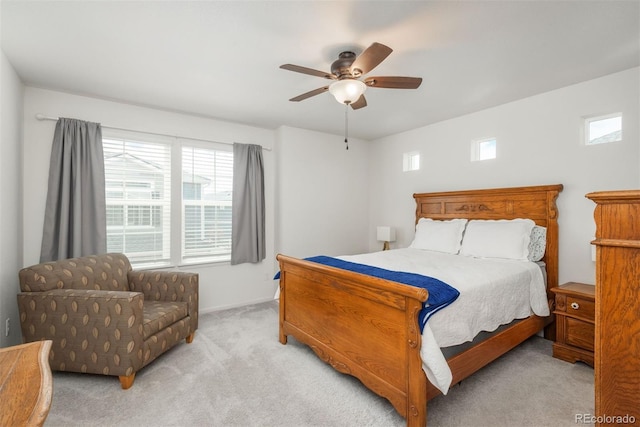 carpeted bedroom featuring multiple windows, ceiling fan, and baseboards