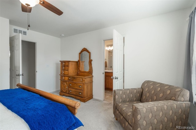 bedroom with light carpet, ensuite bathroom, ceiling fan, and baseboards