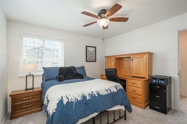 bedroom featuring light colored carpet and ceiling fan