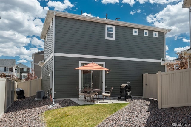 rear view of house featuring a patio and central AC unit