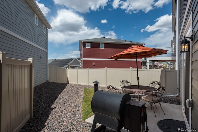 fenced backyard featuring a patio and outdoor dining space