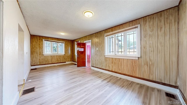 598 S Navajo St, Denver, CO 80223 - entrance foyer with wood finished floors, a textured ceiling, and wooden walls