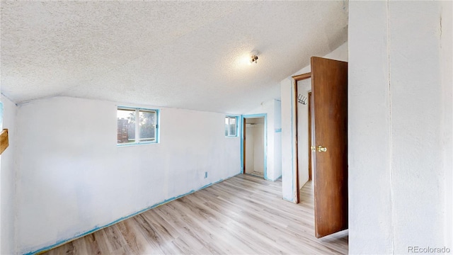 598 S Navajo St, Denver, CO 80223 - unfurnished room with light wood-type flooring, a textured ceiling, and vaulted ceiling