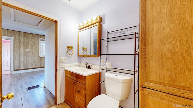 598 S Navajo St, Denver, CO 80223 - half bath featuring vanity, wood finished floors, and crown molding