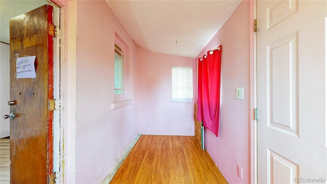 598 S Navajo St, Denver, CO 80223 - corridor featuring light wood-style flooring and a textured ceiling