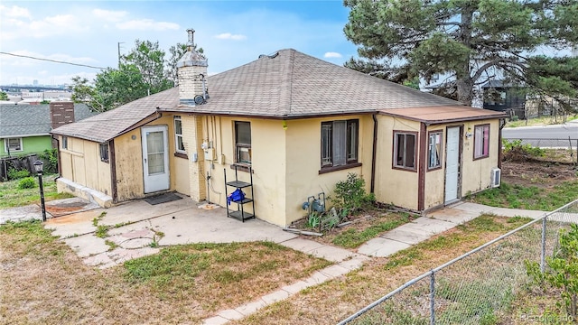 598 S Navajo St, Denver, CO 80223 - rear view of house with a fenced backyard, roof with shingles, a patio, and a chimney