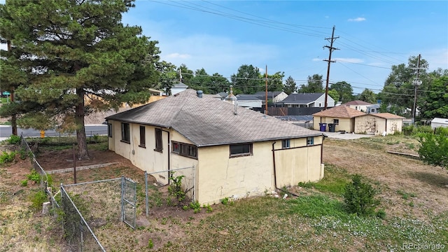 598 S Navajo St, Denver, CO 80223 - view of property exterior with roof with shingles and stucco siding