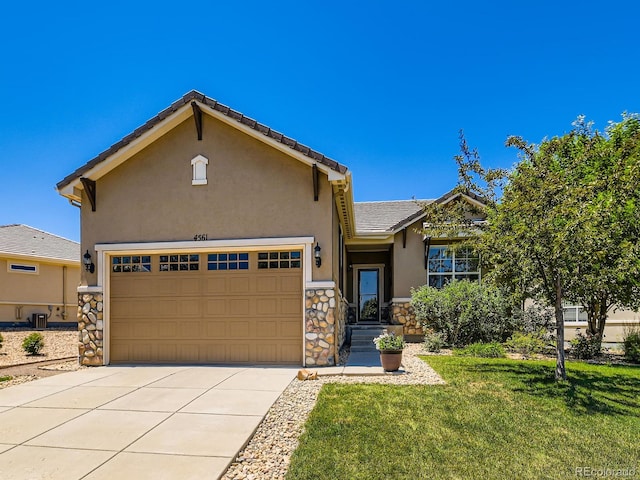 4561 Hope Cir, Broomfield, CO 80023 - view of front facade featuring stucco siding, concrete driveway, a front lawn, a garage, and stone siding