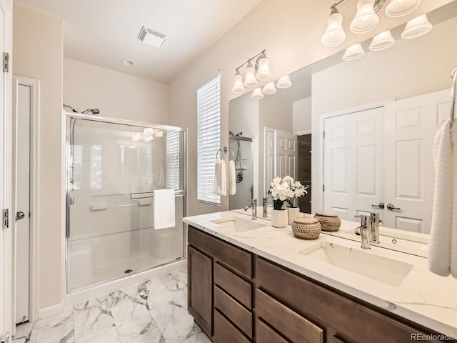 4561 Hope Cir, Broomfield, CO 80023 - bathroom with marble look tiles, a shower stall, and double vanity