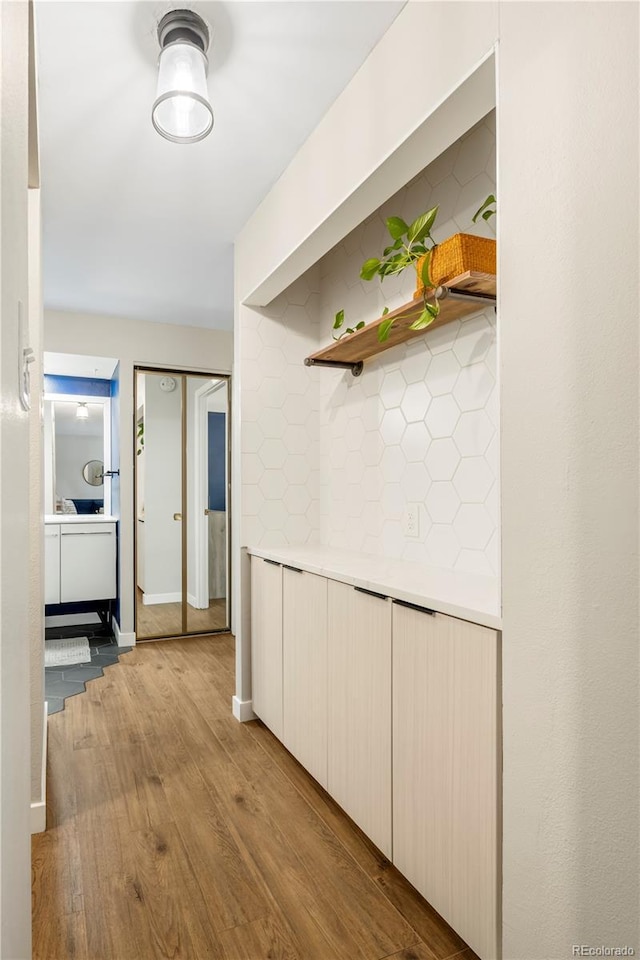 hallway with light hardwood / wood-style floors