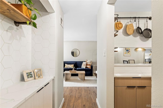 corridor with hardwood / wood-style flooring